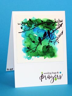 a card with watercolor painting of two birds on a tree branch and the words, sending hugs & prings