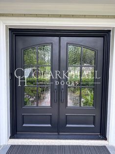 a black double door with glass panels and sidelights