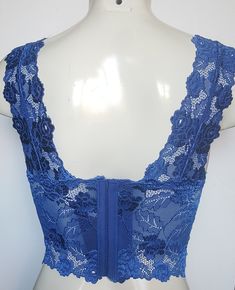 Hand decorated sleeveless lace crop top in Royal Blue color with floral pattern beading with matching sequins and beads. 1. Perfect for any occasion. 2. Available in 4 sizes XS, S, M, and L. 3. Has three rows of hooks-eye closure at the back. 4. Made from stretch lace which helps you adjust to your body size. 5. Individually hand beaded. 6. Light in weight and comfortable. 7. Has cotton lining in the inner bust area to block transparency. 8. Free USPS First Class shipping within the USA. Shippin Fitted Crop Top With Built-in Bra For Party, Evening Crop Top With Built-in Bra For Spring, Fitted Crop Top With Built-in Bra For Summer, Lace Crop Top With Built-in Bra, Fitted V-neck Tank Top For Spring, Fitted V-neck Lace Top For Party, Bra-friendly Fitted V-neck Tank Top, Lace Crop Top With Built-in Bra And Stretch, Fitted Lace Cami Crop Top