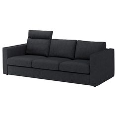 a black couch sitting on top of a white floor