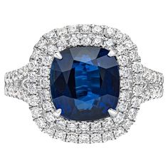 a blue sapphire and diamond ring with white diamonds on the sides, set in 18k white gold