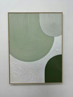 an abstract painting in green and white on a wall