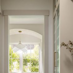 an arched window in a hallway with white walls