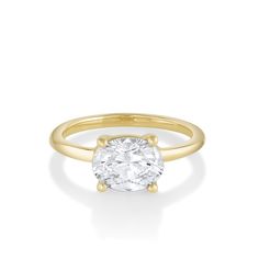 a yellow gold ring with an oval cut diamond