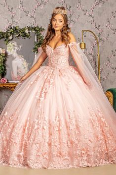 a woman in a pink wedding dress posing for the camera