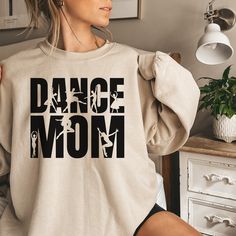 Dance Mom Shirt, Dance Competition Sweatshirt, Dance Competitions Gift, Dance Teacher Gift, Dance Mom Era, Gift for Dance Mom Garment Types & Features 💞Gildan Crewneck 18000 Unisex Heavy Blend Crewneck Sweatshirt💞 Medium-heavy fabric (8.0 oz/yd² (271.25 g/m Loose fit Runs true to size 50% cotton, 50% polyester Sewn-in label 🧼HOW TO CARE INSTRUCTIONS🧼 Machine wash at a low heat.  Wash garments inside-out, with similar colors.  Avoid using bleach.  Use non-chlorine bleach if necessary.  Do not use fabric softeners.  Tumble dry on a low cycle.  Hang dry for a longer life.  Cool iron inside-out.  Do not iron directly on the print.  Do not dry clean. 📦SHIPPING📦 Processing time is 1-3 days, shipping 2-5 days. FREE shipping with orders of $35 and up! If there is a specific date that you nee Long Sleeve Cotton T-shirt For Dance, Dance Mom Sweatshirt Ideas, Dance Sweatshirt Ideas, Cotton Graphic Print Sweatshirt For Dance, Dance Mom Sweatshirt, Relaxed Fit Crew Neck T-shirt For Dance Class, Graphic Print Crew Neck T-shirt For Dance Class, Dance Competition Gifts, Dance Mom Shirt