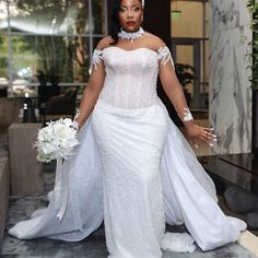 a woman in a white wedding dress and veil