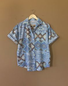 "Authentic vintage short sleeve button down shirt with 90's abstract design and oversized fit. Dates from early to late 90's. This shirt is in great clean condition with little signs of previous wear. Full button down front. Soft 100% cotton. Still has many years of wear left. Measurements (taken zipped/buttoned up and laid comfortably flat) x2 for circumference No Tag Size (Fits like Oversized Large) Shoulders 46\"/48\" Chest 44\" Bottom hem circumference 44\" Sleeve 6\" Top arm circumference 1 Relaxed Fit Collared Hawaiian Shirt With Buttons, Collared Hawaiian Shirt With Buttons And Relaxed Fit, Casual Patterned Blouse With Retro Print, Retro Button-up Summer Shirt, Retro Camp Shirt With Relaxed Fit And Short Sleeves, Retro Short Sleeve Camp Shirt With Relaxed Fit, Retro Button-up Shirt For Summer, Retro Summer Short Sleeve Shirt With Button Closure, Retro Short Sleeve Shirt With Button Closure For Summer