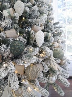 a decorated christmas tree with silver and gold ornaments