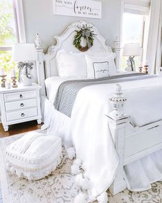 a bedroom with white furniture and decor