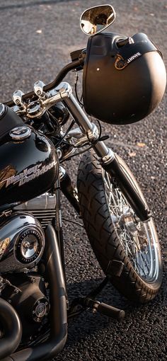 a black motorcycle parked on top of a parking lot