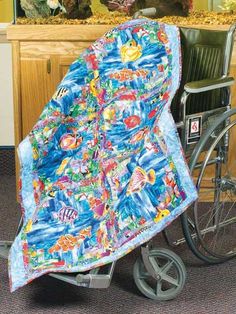 a wheelchair with a blanket on it in front of a fish tank