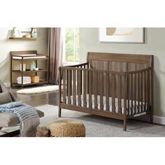 a baby crib in a living room next to a couch