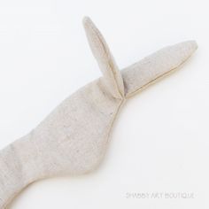 a white rabbit made out of fabric on a white surface