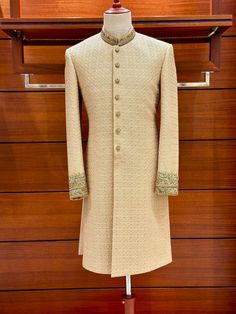 Presenting our exquisite golden embroidered karandi sherwani, a work of art created just for the groom on his wedding day. The gorgeous hand-stitched zardozi design embellishing the cuffs and ban is set off by a base of pure karandi. Our dedication to exceptional quality is evident in all the minute details. This sherwani's majestic atmosphere is enhanced by the tasteful vintage colour palette. Every piece is made to order and has a personalized touch. For the ideal fit, expect a measurement form and a call. Production takes 15-21 days, and then 3-6 days for quick shipping via FedEx or DHL. The sherwani and inner suit--which comes with your choice of shalwar, pant, or pajamas--are included in the bundle. Customize your outfit to your style; the choice is yours! Please be aware that because Semi-stitched Gold Kurta With Naqshi, Traditional Gold Raw Silk Wear With Naqshi, Gold Jamawar Sets With Naqshi Details, Festive Gold Kurta With Naqshi Detail, Gold Sherwani With Gold Embroidery, Semi-stitched, Festival Gold Unstitched Suit With Naqshi Detail, Festive Gold Kurta With Naqshi, Unstitched Gold Traditional Wear With Naqshi, Bollywood Style Gold Traditional Wear With Naqshi