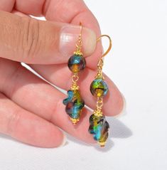 Venetian Style Glass / Murano Style Glass Earrings - Fun colors! (1)  Venetian Glass Foil earrings (22) -  8mm round and 14x8mm twist - gold-plated ear wire - Overall earring length is 2 inches (2)  Venetian Glass Foil earrings (23) -  8mm round and antiqued copper hammered link - antiqued copper  ear wire - Overall earring length is 1.85 inches (3)  Venetian Glass Foil earrings (24) -  8mm round and antiqued copper hammered link - antiqued copper  ear wire - Overall earring length is 1.85 inches (4)  Venetian Glass Foil earrings (25) -  8mm round and antiqued copper hammered link - XL copper  ear wire - Overall earring length is 2 inches (5)  Venetian Glass Foil earrings (26) -  8mm round - gold-plated ear wire - Overall earring length is 1.2 inches (6)  Venetian Glass Foil earrings (27) Multicolor Glass Drop Earrings, Unique Gold Glass Earrings, Elegant Glass Dangle Earrings, Gold Glass Earrings For Pierced Ears, Glass Drop Earrings With Lever Back Ear Wires, Glass Dangle Earrings For Pierced Ears, Unique Glass Dangle Earrings, Elegant Multicolor Plug Earrings For Gift, Earrings Multiple