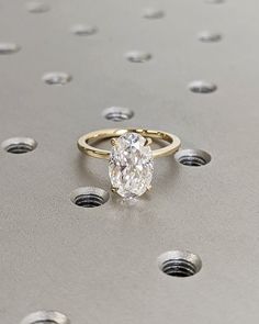 a diamond ring sitting on top of a metal surface