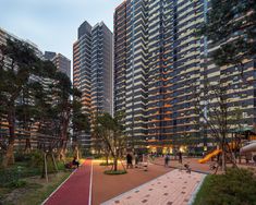 an empty playground in front of tall buildings