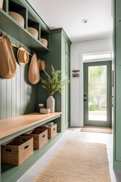 a hallway with green cabinets and baskets on the wall