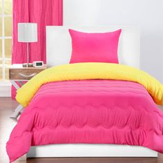 a bright pink and yellow bed in a bedroom