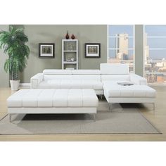 a living room with a white sectional couch and coffee table