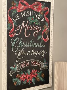 a chalkboard sign that says we wish you a merry christmas and a happy new year