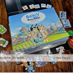 the blue busy book is sitting on top of a wooden table