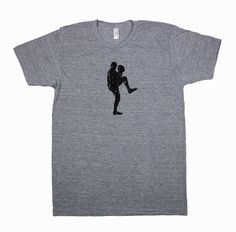 a grey t - shirt with a silhouette of a man holding a woman's leg