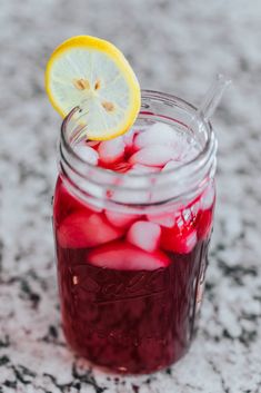 a mason jar filled with ice and lemon wedges