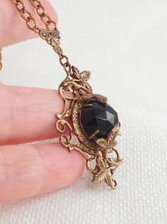 This very dramatic 40's necklace has lots of dimension and texture with a center faceted dome onyx stone set in swirled brass and leaves hangs on a 16 1/2 inch rolo links brass chain with a spring roll clasp which works well the pendant measures 2 by 1 1/4 and is 1/2 of an inch in depth I believe this is a Czech necklace, but I do not see any marks in excellent condition and way better than my picspromise! If you love sterling silver and other vintage necklaces, be sure to check out others I hav Czech Glass Necklace, Peace Sign Necklace, Goth Necklace, Spring Roll, Halloween Necklace, Vintage Necklaces, Skull Necklace, Cross Bracelet, Glass Dome