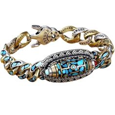 a blue and gold bracelet with an ornate design on the clasp, featuring two different colored stones