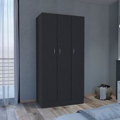 a bedroom with a bed and two black cupboards in front of a window on the wall