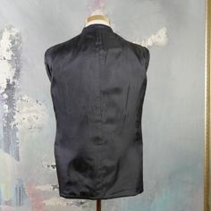 "This navy blue double-breasted blazer has notch lapels and padded shoulders, and closes in the front with one button (four in total show on the front). Three buttons decorate each sleeve cuff. The dark blue wool-blend jacket has three pockets on the front, and is fully lined in a navy blue satin viscose fabric (with two inner pockets). The fabric has a double pinstripe pattern, with a textured chevron herringbone running vertically as well. Brand label: Turo (Made in Finland) Size: 40 US/UK Mat Navy Notch Lapel Blazer With Double-breasted Button Fastening, Navy Blazer With Double Button And Lapel Collar, Navy Blazer With Double Button Closure And Lapel Collar, Blue Double-breasted Business Blazer, Blue Double-breasted Suit With Button Closure, Blue Double-breasted Blazer For Business, Navy Blazer With Double Button Closure And Suit Collar, Business Blue Double-breasted Blazer, Navy Fitted Double-breasted Outerwear