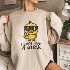 Cool duck shirt, ducky sweatshirt, funny shirt, swag duck sweatshirt,gift shirt, cute duck sweatshirt,unisex sweashirt Gift Gildan Unisex Heavy Sweatshirt - Loose fit - 50% Cotton; 50% Polyester (fibre content may vary for different colors) - Medium fabric (8.0 oz/yd² (271.25 g/m - Sewn in label - Runs true to size Mens fitted, order one size up for looser feel. Women should order one or two size down if they prefer a slimmer feel. Please refer to chart size in listing photos for details. Side-s Ducky Clothes, Cool Duck, Duck Sweatshirt, Funny Animal Shirts, Duck Shirt, Cute Duck, Custom Printed Shirts, Funny Tshirt, Tshirt Funny