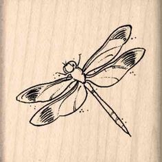 a rubber stamp with a drawing of a dragonfly on it's back end