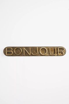 the word bonjou written in gold on a white background