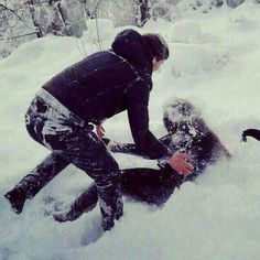 two people are playing in the snow while one person is on his knees and another man has fallen