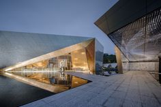 the exterior of a building that is reflecting in water