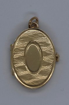 This hand-made oval locket is as sentimental as it gets. It is a beautiful holiday present. It is both beautiful and functional. Most lockets can hold 2 pictures but this one can hold 4 special photos close to your, or your loved one's, heart! It also has room to be personalized with an initial monogram. It is hard to match the workmanship of this locket. It was crafted by a very talented jeweler in the NYC jewelry district between 1970 - 1980. Lockets are his legacy and his remaining inventory Oval Cameo Keepsake Jewelry, Luxury Yellow Gold Oval Locket Necklace, Luxury Oval Locket Necklace As Gift, Timeless Gold Oval Locket Necklace, Timeless Oval Locket Necklace For Gift, Timeless Yellow Gold Oval Locket Necklace, Timeless Oval Yellow Gold Locket Necklace, Classic Oval Locket Necklace With Vintage Charm, Heirloom Oval Locket Necklace Keepsake