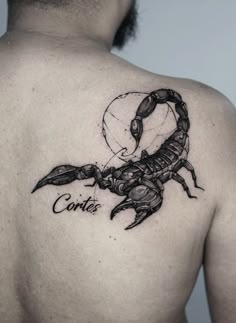 a man's back with a scorpion tattoo on his left shoulder and the word cortier written in black ink