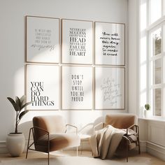 a living room with posters on the wall and chairs in front of it, along with a potted plant