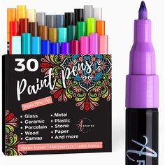 an assortment of markers and pens in front of a box