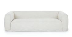 a white couch sitting on top of a white floor