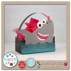 a shark gift bag with pink bows in it