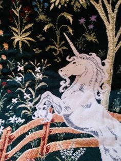 an image of a unicorn on the back of a horse with trees and flowers in the background