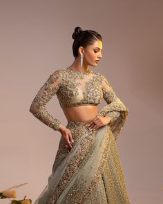 Indian Bridal Dress in Wedding Lehenga and Choli Style is a heavily embellished masterpiece that will give the gorgeous bride a head-turning flawless look on the most important day of her life. Premium quality fabric and perfect stitching make this Lehenga Choli an epitome of beauty. Lehenga Choli: The beautiful choli in a delicate net fabric is beautifully adorned with hand-crafted details of sequins, zardosi, pearls, stones, beads, and embroidery. The lavish blend of colors, floral designs, and shimmering ornaments make this stunning choli a perfect choice to pair with Lehenga. Bridal Lehenga: The Bridal Lehenga is also fully embellished with hand-work of sequins, beads, and tilla. The shimmering silver gold work and intricate designs give a perfect finishing look to this perfectly stitc Choli Style, Bridal Lehenga Indian, Lehenga With Dupatta, Lehenga Bridal, Bridal Dupatta, Indian Lehenga Choli, Indian Bridal Lehenga, Indian Bridal Dress, Indian Bridal Wear