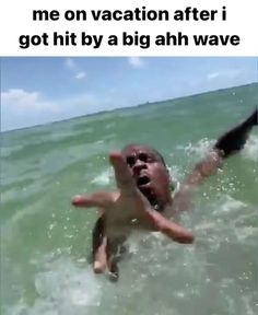 a man is swimming in the ocean with his arms out