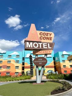 a motel sign in front of a colorful building