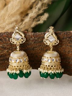 Indulge in the mesmerizing beauty of our Peacock-Shaped Indian Earrings adorned with stunning emerald green pearls. These earrings capture the grace and grandeur of the majestic peacock, a symbol of beauty and abundance in Indian culture, and infuse it with a touch of elegance and enchantment. Crafted with meticulous attention to detail, these earrings showcase the intricate artistry of Indian jewelry-making. The peacock motif, delicately carved with precision, embodies the rich cultural heritage and artistic legacy of India. The radiant emerald green pearls, reminiscent of lush landscapes, accentuate the beauty of these earrings, creating a captivating and harmonious color palette. Wear these earrings with pride and confidence, as they effortlessly become the centerpiece of any ensemble. Green Bridal Earrings With Latkans For Diwali, Green Latkan Bridal Earrings For Diwali, Green Latkans Bridal Earrings For Diwali, Traditional Emerald Earrings For Festive Season, Traditional Festive Emerald Earrings, Green Kundan Chandelier Earrings With Latkans, Green Chandbali Bridal Earrings With Latkans, Green Bridal Earrings With Latkans For Festivals, Green Bridal Earrings With Latkans For Celebration