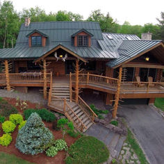 an aerial view of a log cabin with stairs leading up to the upper floor and second story